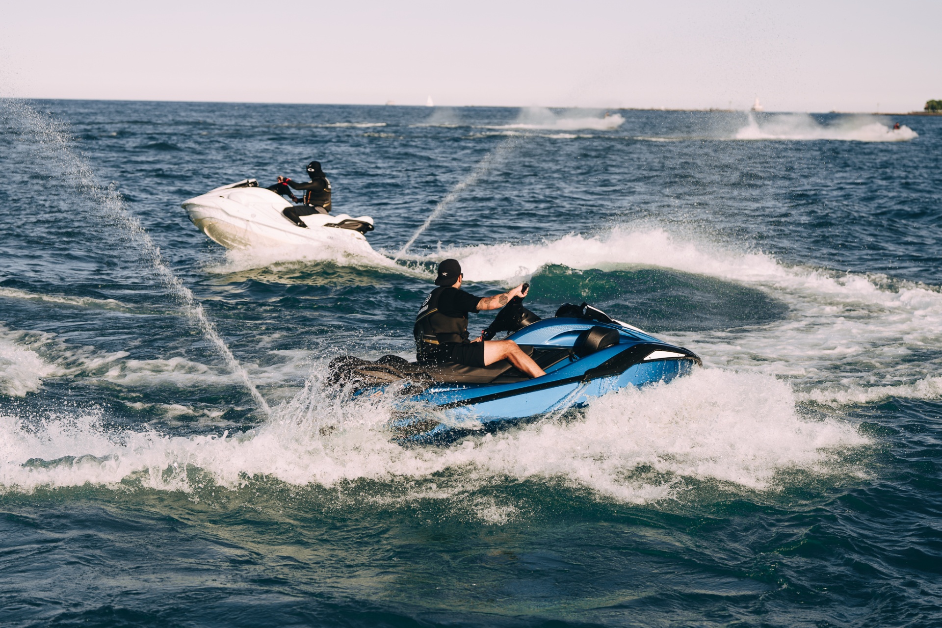 Blue and white FX Cruisers side by side on open water