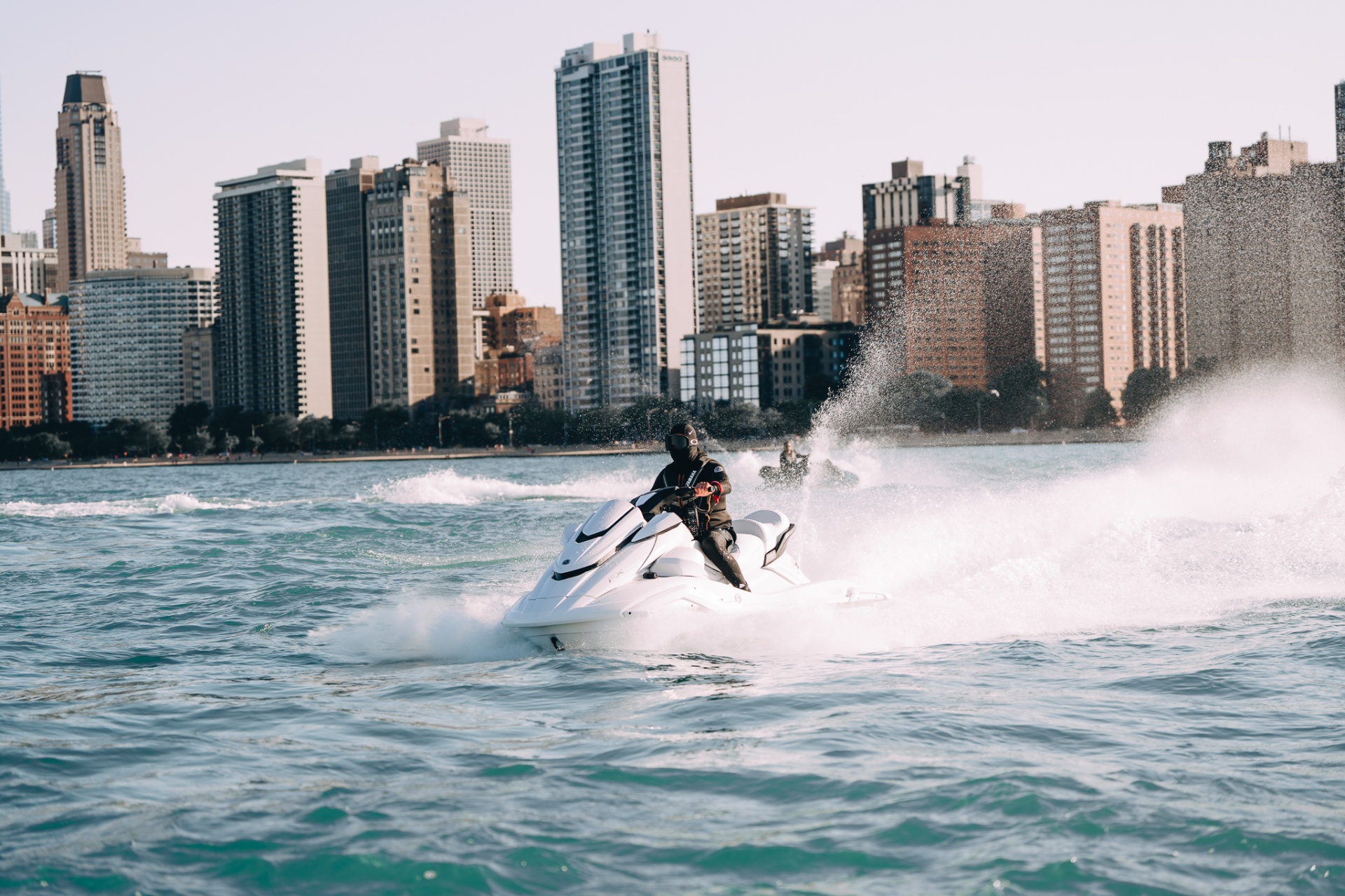 White Yamaha FX Cruiser throwing spray along the Chicago shoreline