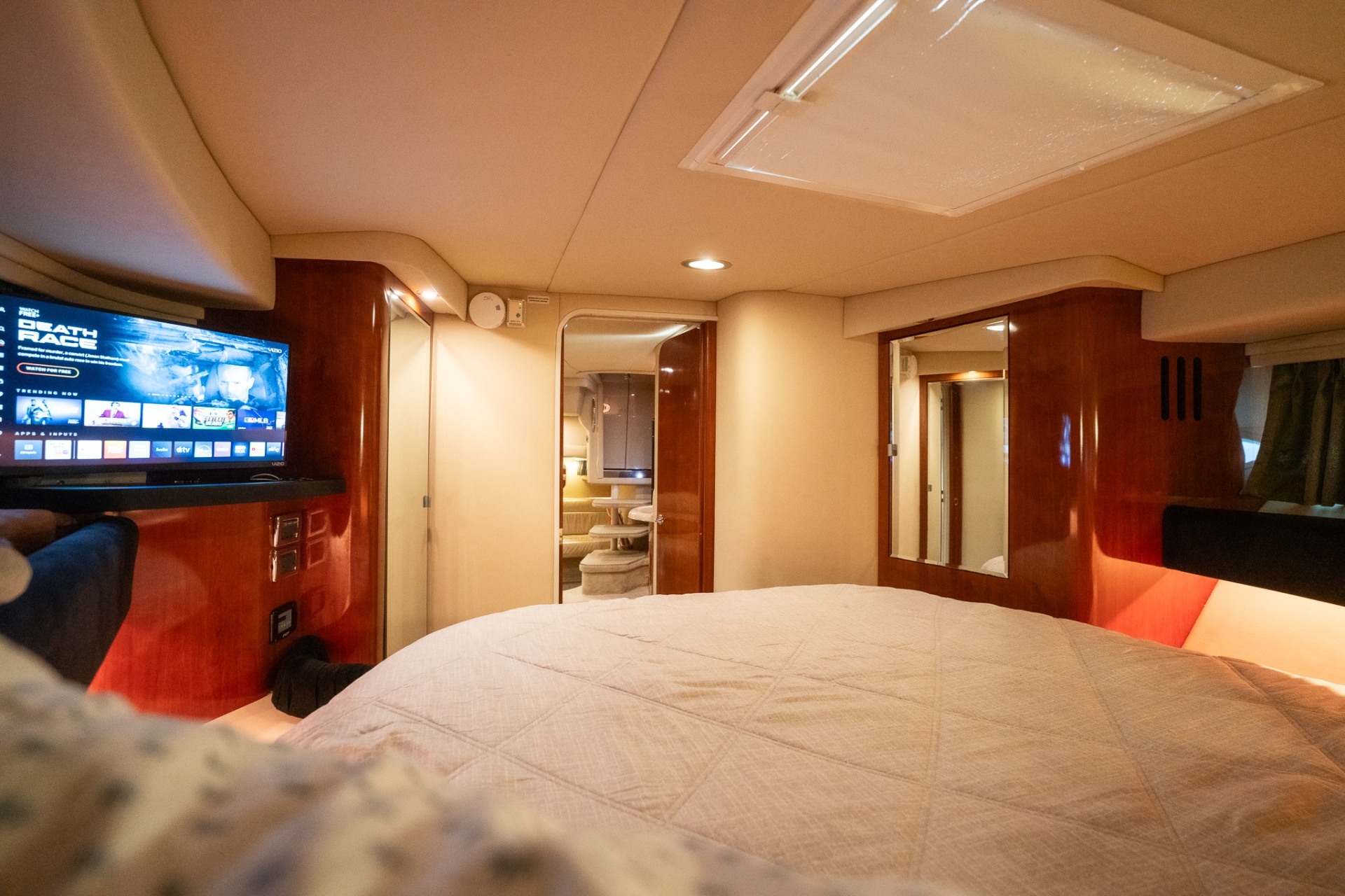 Mid-cabin stateroom with bed and mounted TV