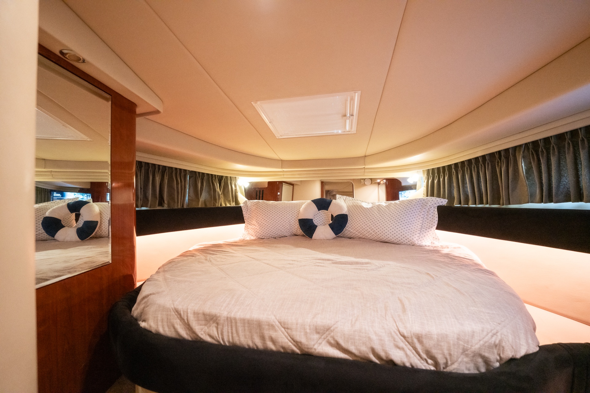Forward stateroom with queen bed and nautical pillows